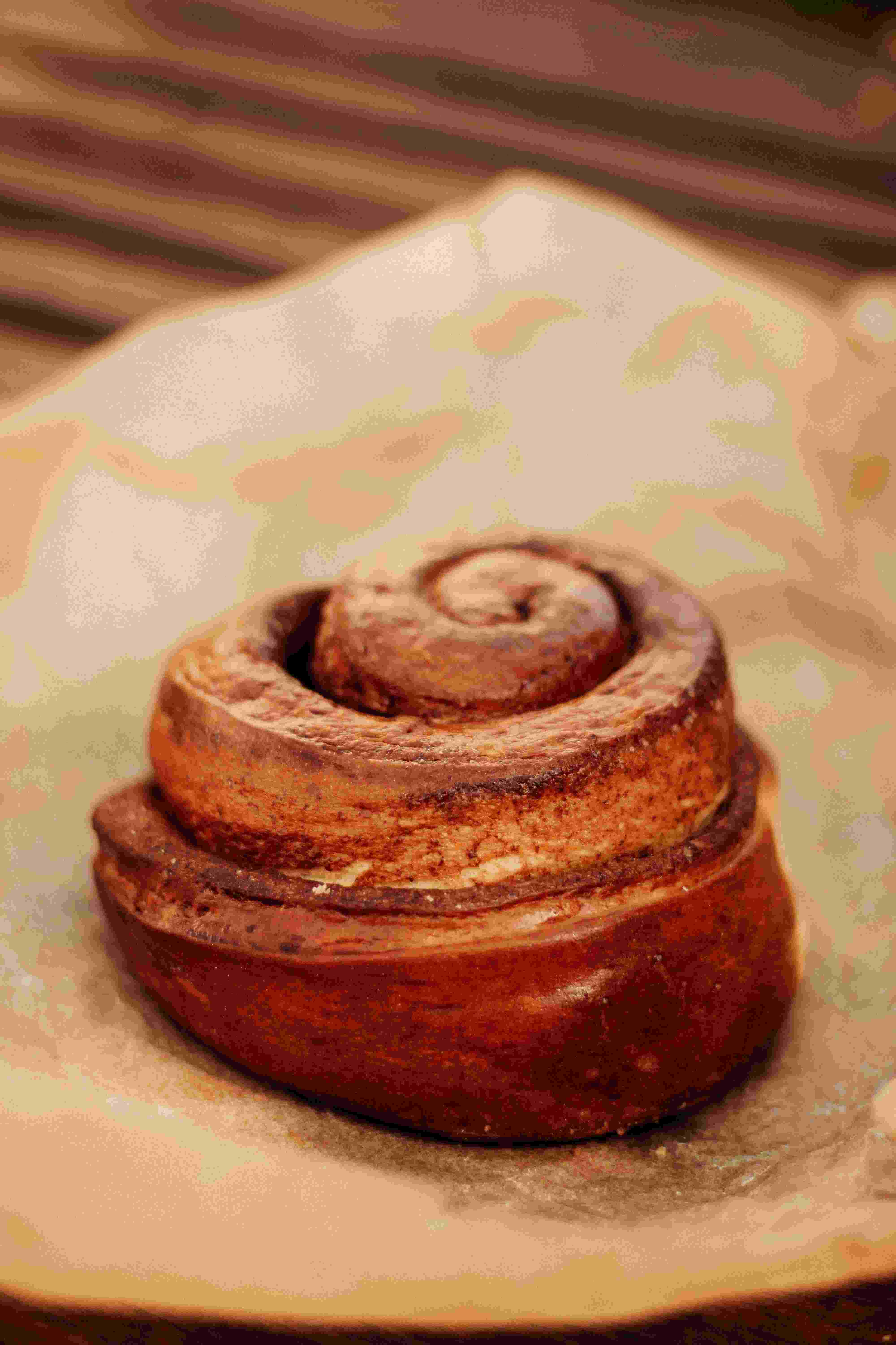A glazed cinnamon roll on a plate