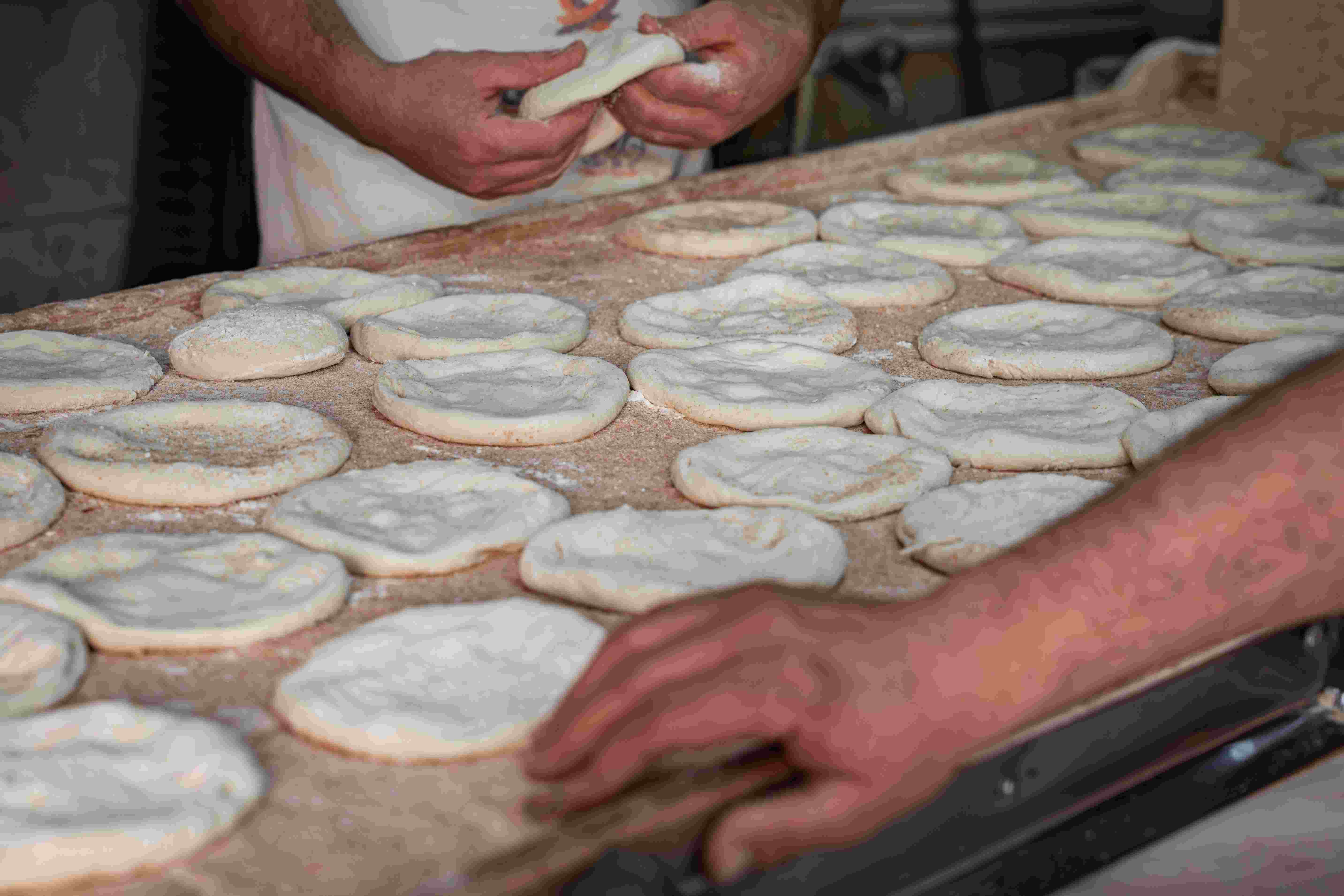 Flour being dusted over fresh dough