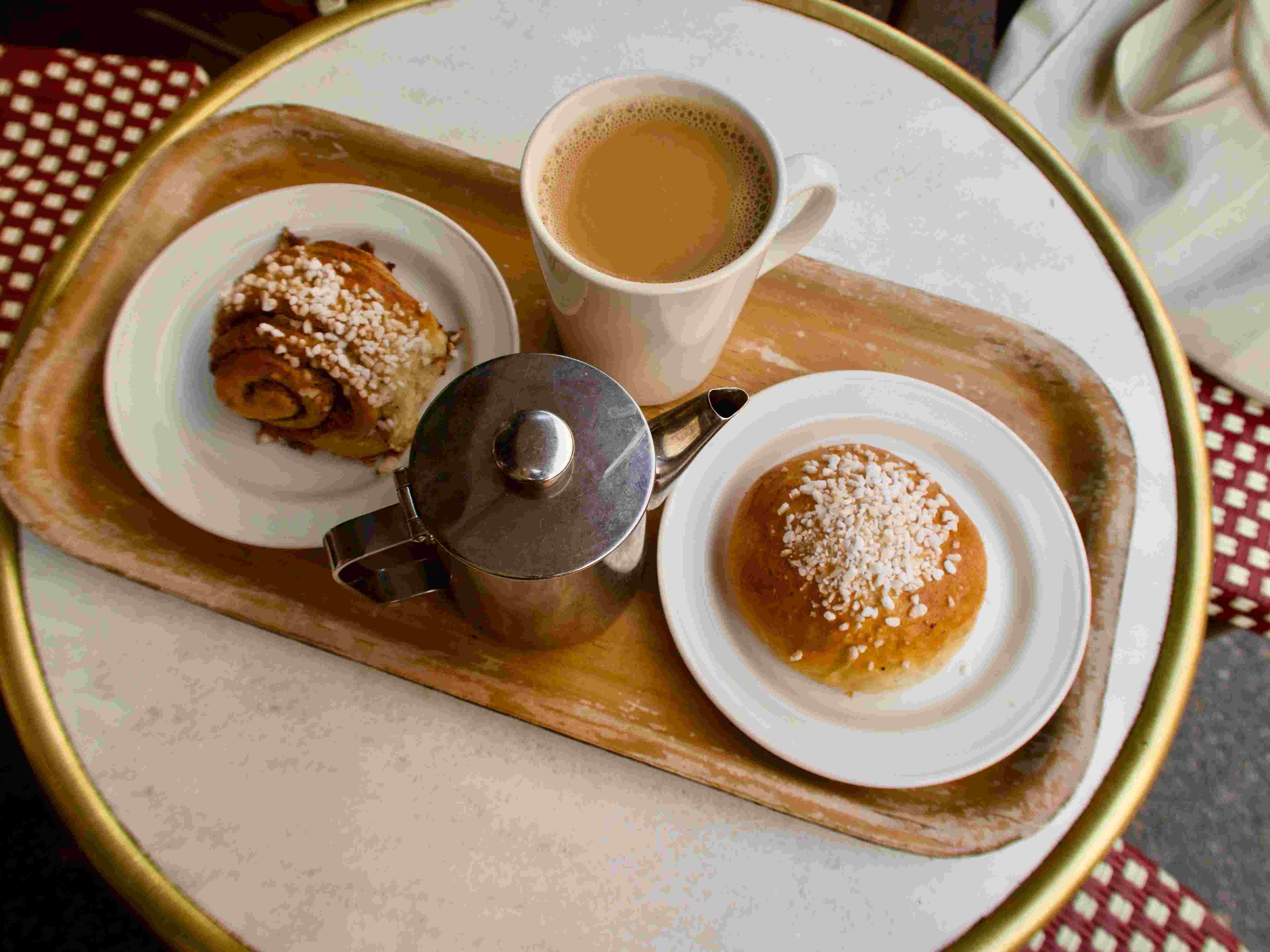 A flat white next to a pastry